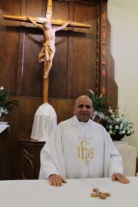 A Picture of Fr. Nusi in fromt of the Altar