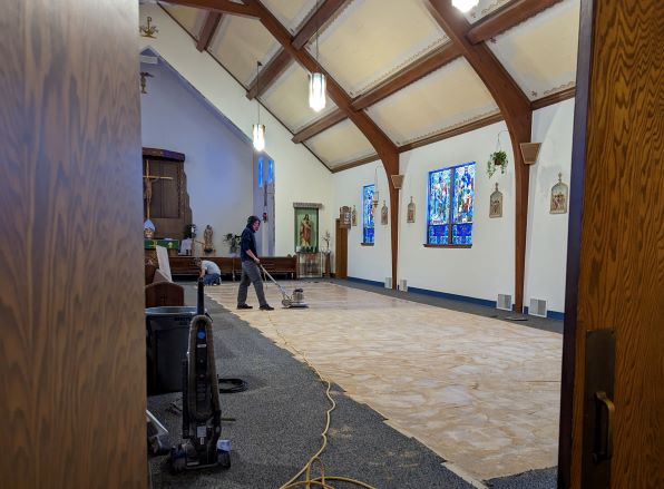 Man using a sanding machine to sand the floor smooth